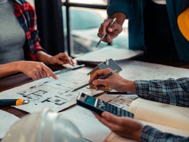 Team reviewing office refurbishment plans and workspace design
