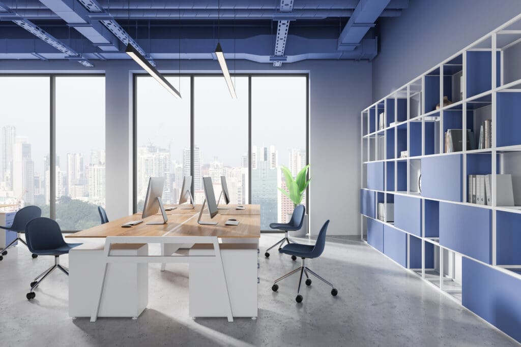 An office space with blue walls and chairs, highlighting how poor planning can negatively affect office design and construction.